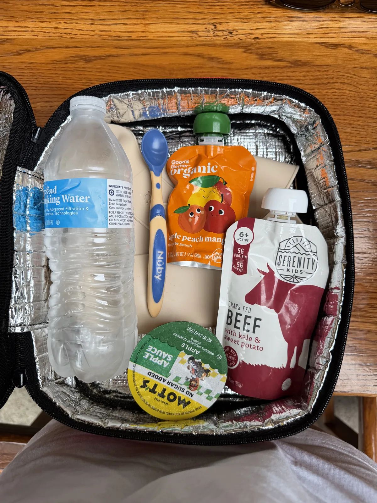 An open insulated bag holding food packed for George’s park day