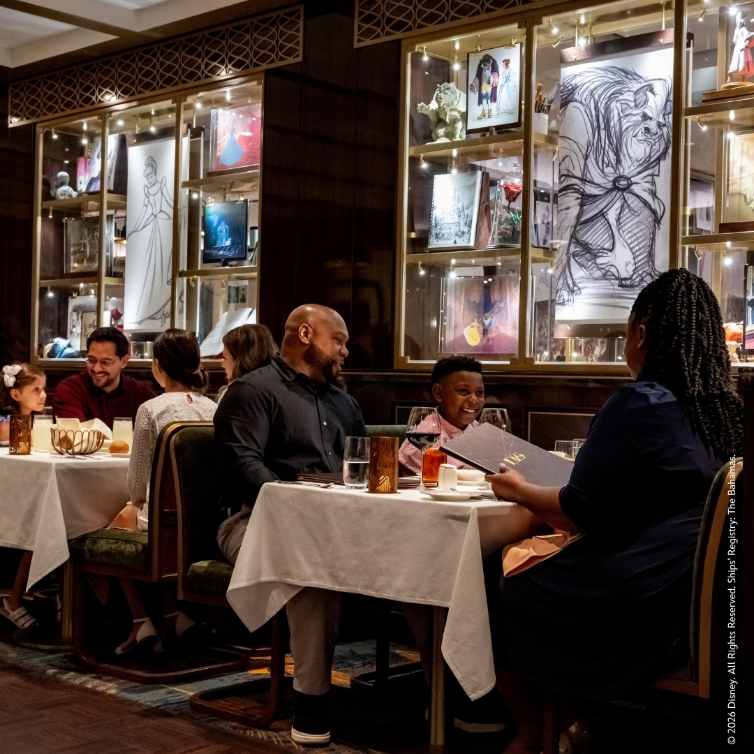 A family dining in the 1923 restaurant aboard Disney Wish, surrounded by animation artwork