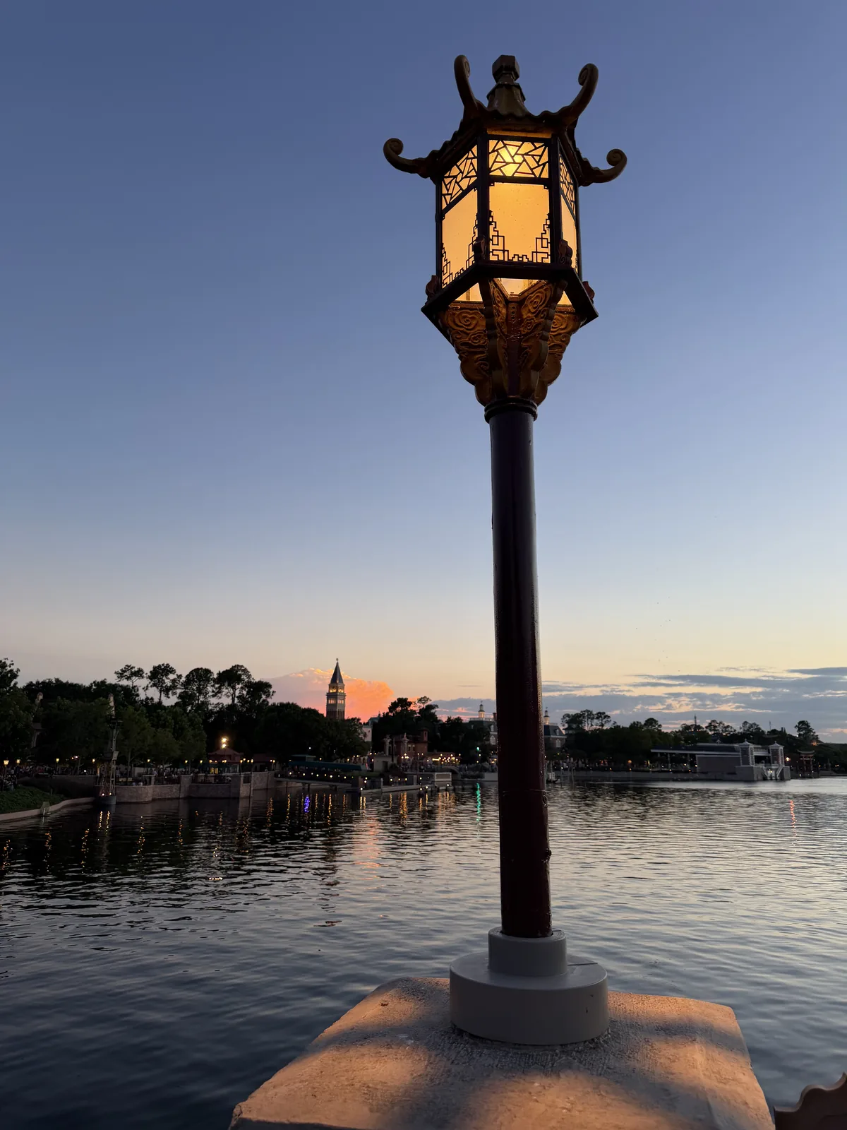 A lantern beside the water at EPCOT at sunset