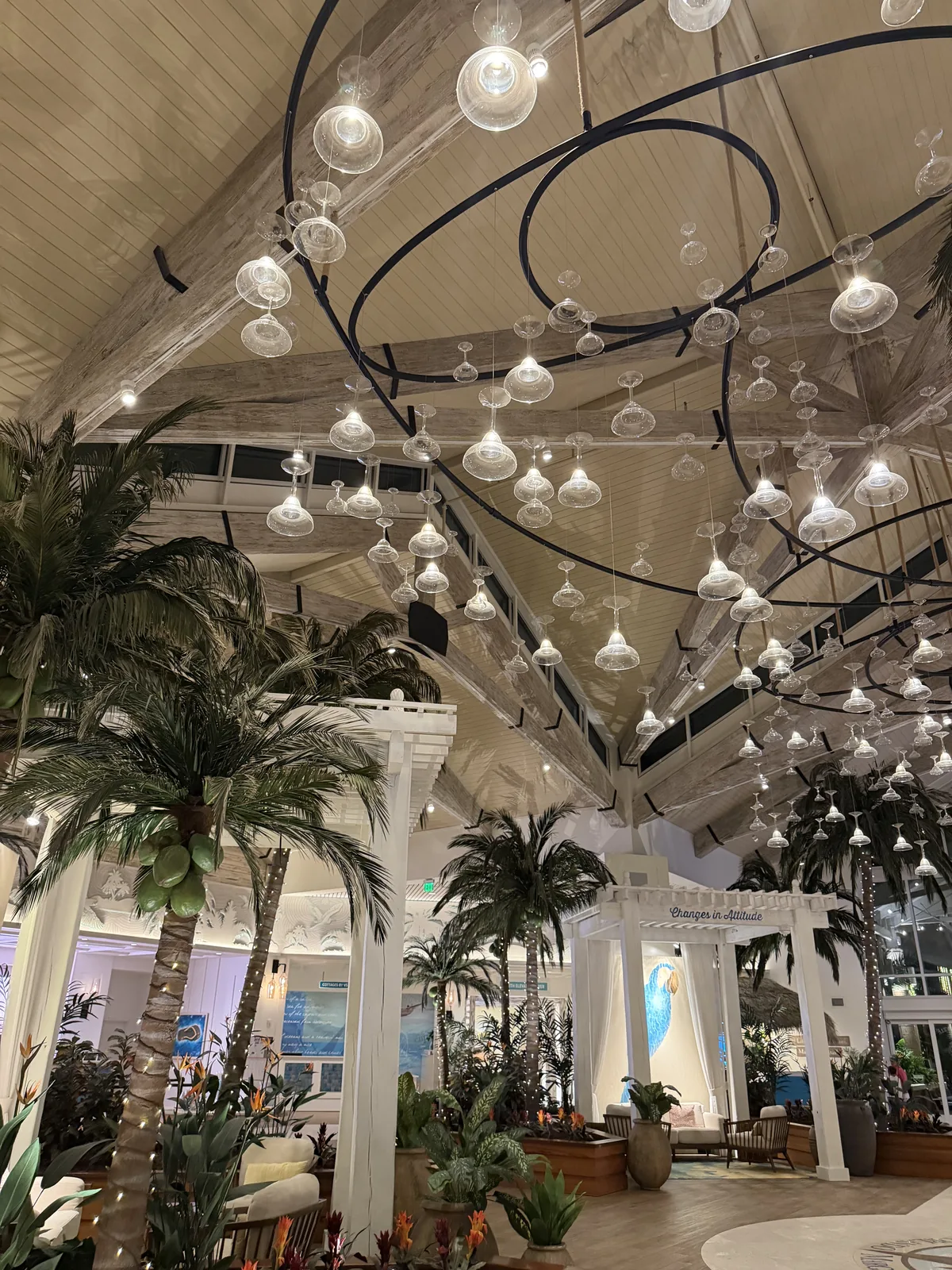 Palm trees and hanging glass lights in the Margaritaville Orlando lobby