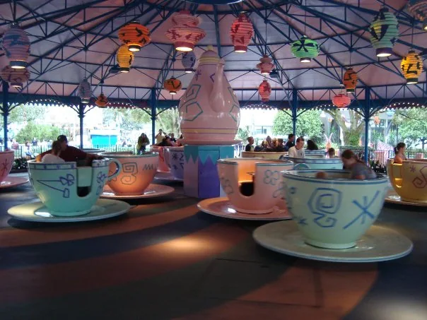 Colourful teacups beneath lanterns on Mad Tea Party at Magic Kingdom.