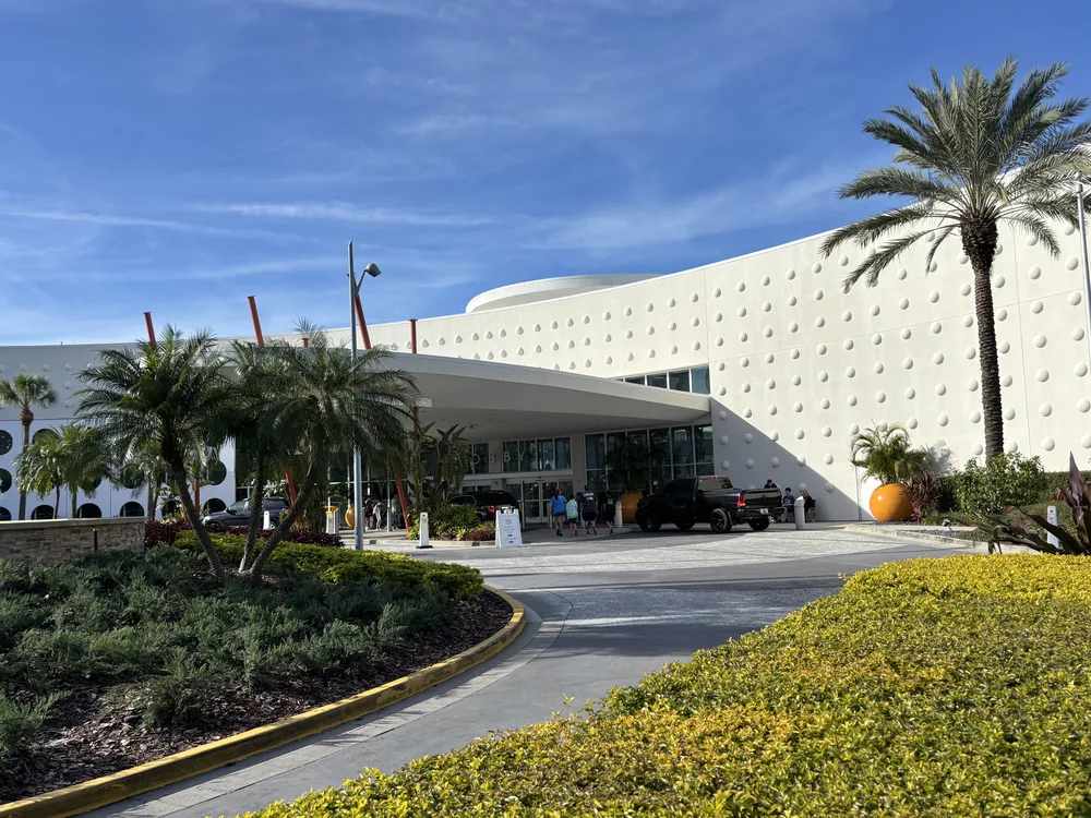 Palm trees and the curved entrance to Universal Cabana Bay Beach Resort.
