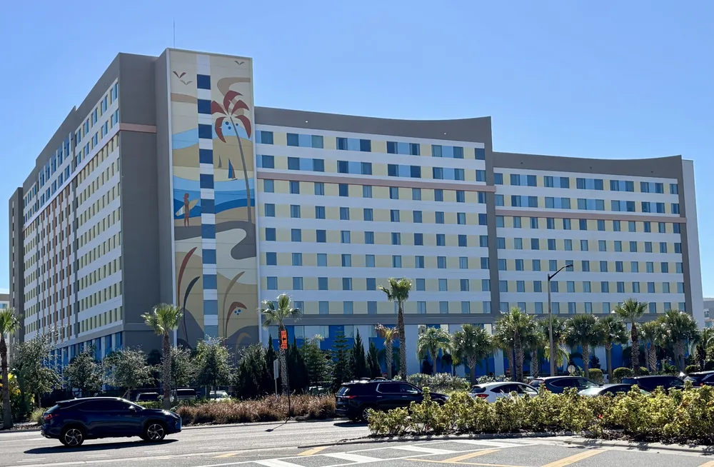 Universal Endless Summer Resort – Dockside Inn and Suites, with its colourful tower mural and palm-lined exterior.